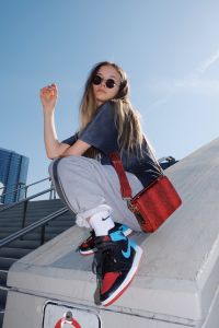 sports styling with red bag
